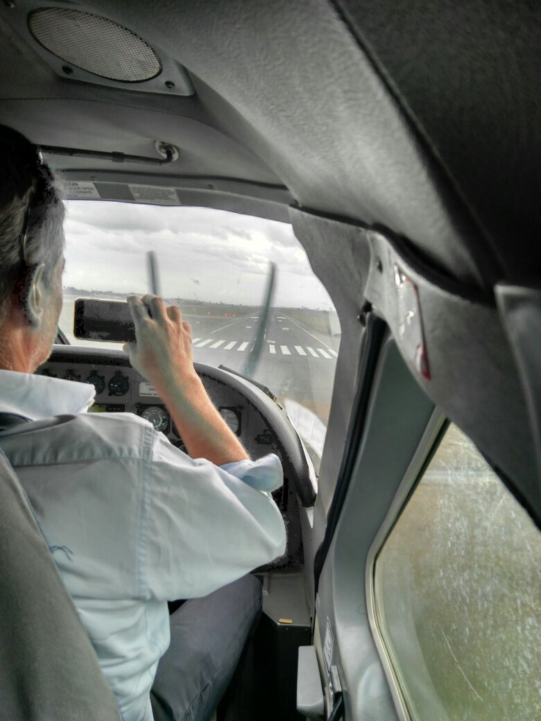 The pilot of a small bush plane at the controls on a flight to Ruaha