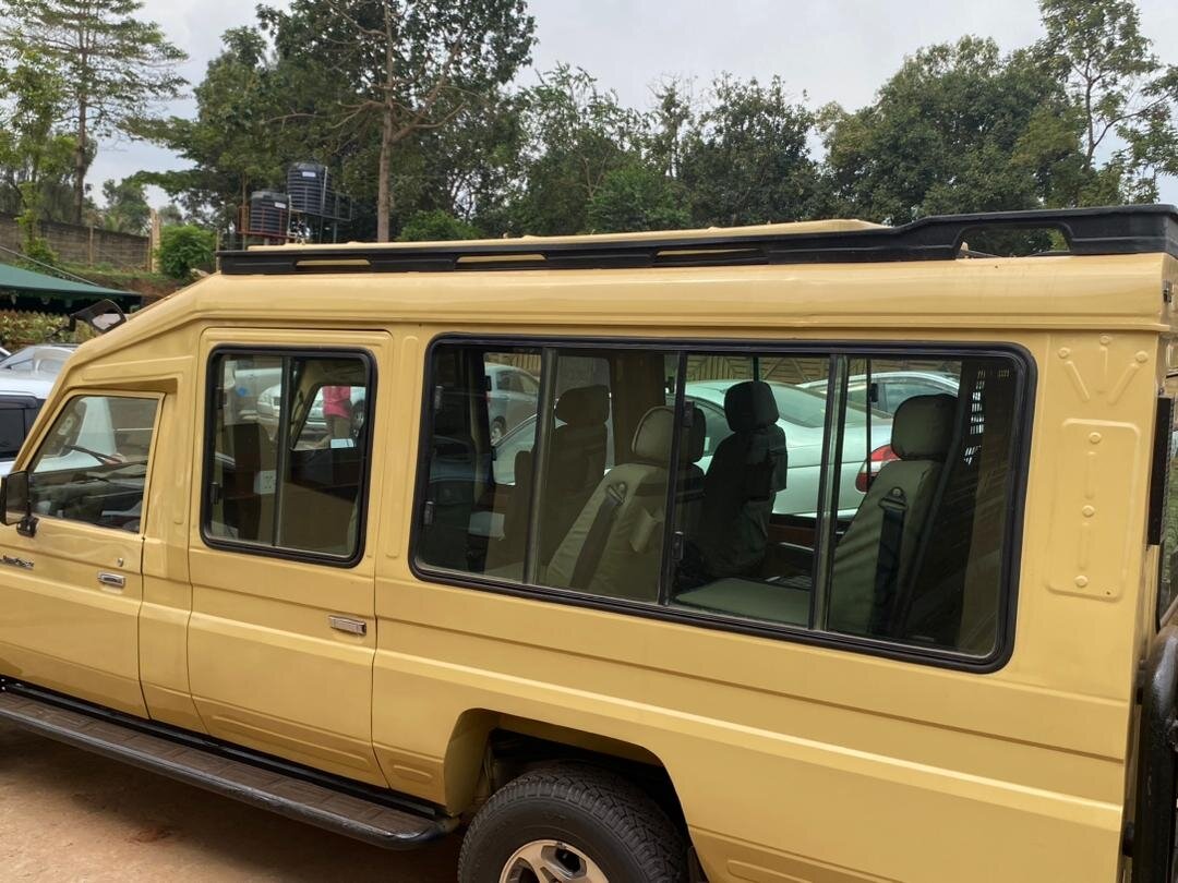 Yellow pop-top safari Land Cruiser parked in the bush